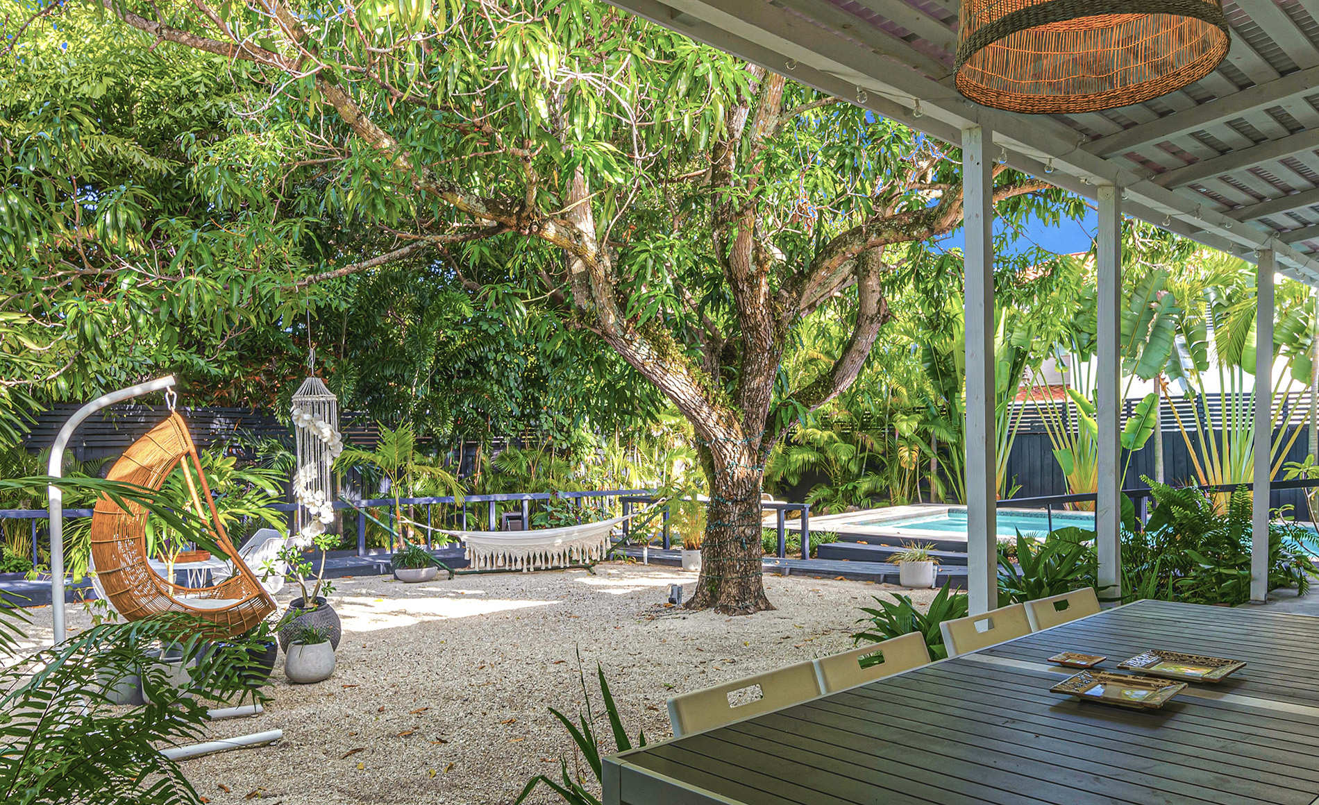 Coconut Grove home renovation - backyard porch with a view to the pool, designed by Beatrice Leupold